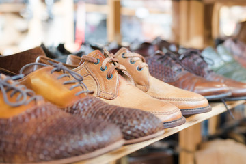 Men's shoes on shelf. Selective focus and close up