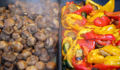 Sweet pepper and mushrooms on the grill in close up. Roasted vegetables
