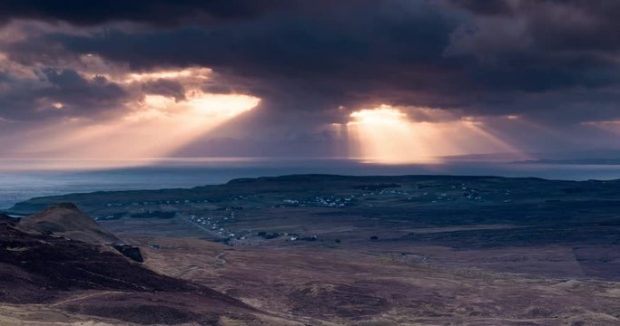 Time lapse clip of crepuscular rays over sea and village of Staffin in Isle of Skye, Scotland.