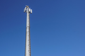 Technology on the top of the telecommunication GSM 4G tower antenna, transmitter , blue sky, white...