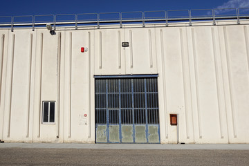 Cargo gate of Industrial warehouse. Industrial door. View on the one gates of big warehouse facade. Front view