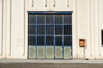 Cargo gate of Industrial warehouse. Industrial door. View on the one gates of big warehouse facade. Front view