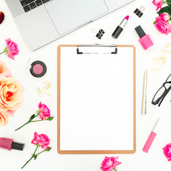 Laptop, clipboard, roses flowers and accessories on white background. Flat lay. Top view. Freelancer office concept