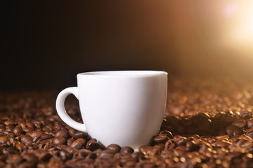 Portrait of a cup of Italian coffee on the wooden backdrop with coffee beans to be grinded....