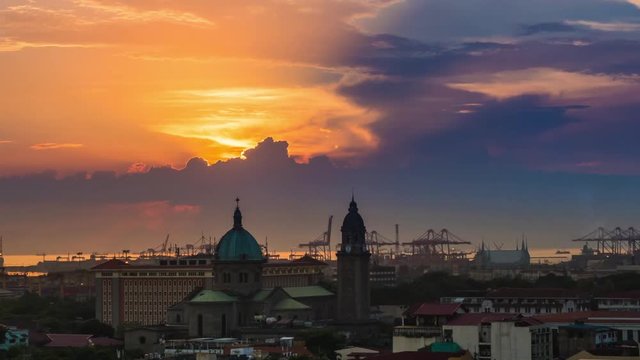Time lapse view of sunset over the Manila Cathedral in Intramuros, Metro Manila, Philippines. Zoom out.