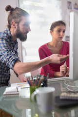 Two colleagues, man and woman sharing ideas about a project
