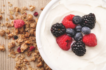 Composition of a typical genuine breakfast made with strawberry yogurt and granola. Concept of: fitness, diet, wellness and strawberries.