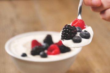Composition of a typical genuine breakfast made with strawberry yogurt and granola. Concept of: fitness, diet, wellness and strawberries.