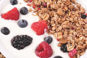 Composition of a typical genuine breakfast made with strawberry yogurt and granola. Concept of: fitness, diet, wellness and strawberries.