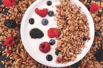 Composition of a typical genuine breakfast made with strawberry yogurt and granola. Concept of: fitness, diet, wellness and strawberries.