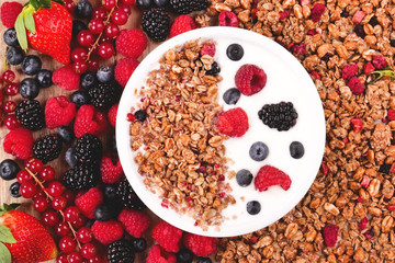 Composition of a typical genuine breakfast made with strawberry yogurt and granola. Concept of: fitness, diet, wellness and strawberries.
