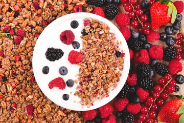 Composition of a typical genuine breakfast made with strawberry yogurt and granola. Concept of: fitness, diet, wellness and strawberries.