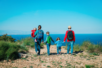 family with three kids hiking travel in scenic nature