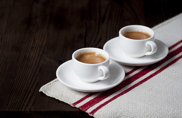 3803891 Two cups of espresso on a textured linen napkin