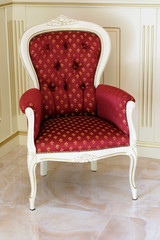 Vintage red armchair. Vintage interior with a red armchair in guest reception room.