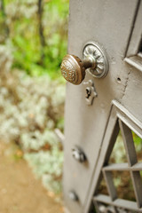 Vintage lever from an old metallic house gate. Metallic lever with vintage decoration from house gate entrance.