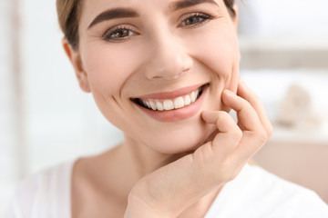 Young woman with beautiful smile indoors. Teeth whitening