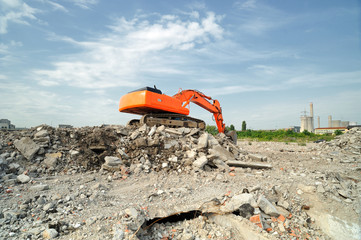 Demolition construction site in daytime. Crawler excavator working on demolition site in daytime.