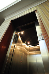 Modern elevator with open doors. Angle view of a modern elevator with open doors inside hotel lobby.