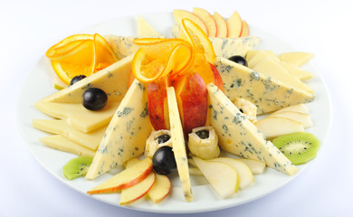 Gourmet cheese. Different types of cheese on the white plate against white background.