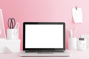 Laptop macbook screen on a bright pink background school workspace. 
