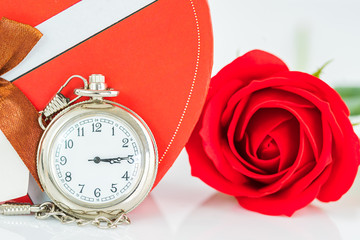 Close up pocket watch and red roses flower