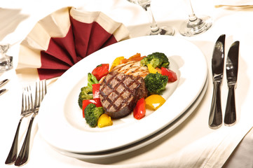 Barbecue with  cow meat and vegetables mix on the white plate.