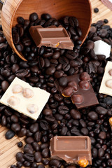 Coffee beans with black and white chocolate pieces.