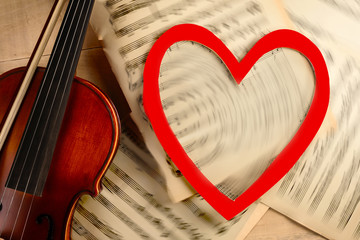 violin notes and heart on a wooden table