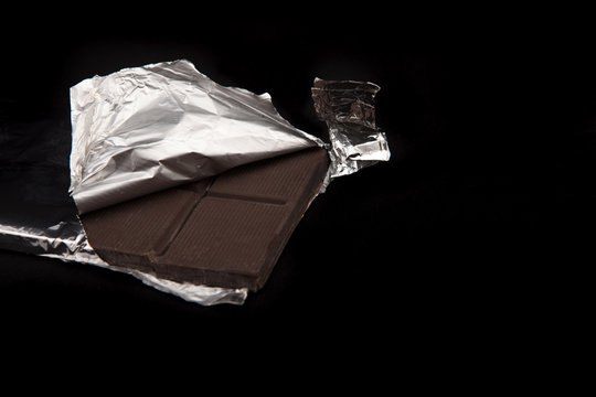 Chocolate Bar Wrapped In Aluminum Foil In The Dark ..