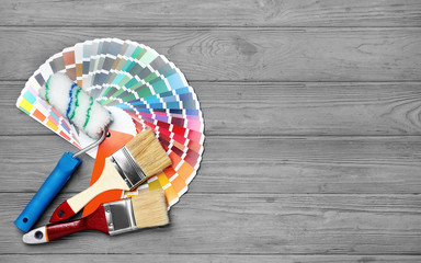 Set of decorator's tools on wooden background, flat lay