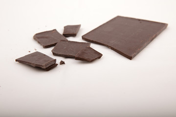 Dark milk chocolate bars stack isolated on a gray cloth
