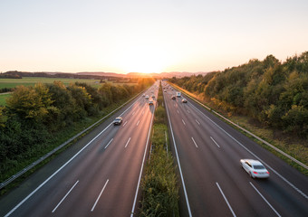 The road traffic on a motorway at sunset