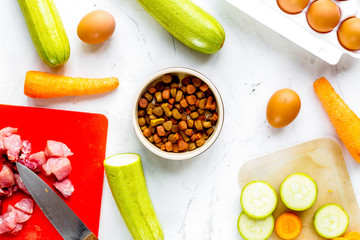 organic pets food with eggs, zucchini and carrot white backgroun