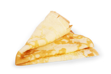Pancakes on a saucer on a kitchen towel. Many pancakes are stacked. Thin pancakes with crispy crust. Maslenitsa. Pancakes for breakfast and carnival. Food background