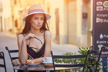 Stylish sexy lady waiting for someone at restaurant. rich slim brunette girl with long glossy hair at vacation resting at bar.