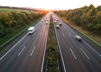 The road traffic on a motorway at sunset
