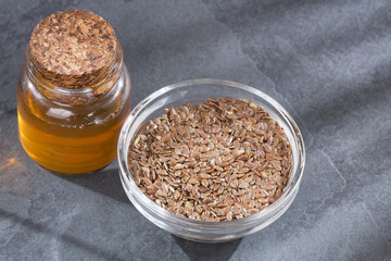 Organic flax seeds and oil in the bottle - Linum usitatissimum