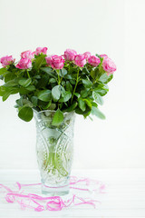 a bouquet of roses in a crystal vase