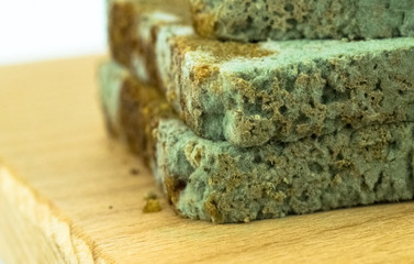 Spoiled food. Stout moldy bread on a cutting board