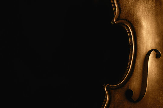 Half of a violin on a black background