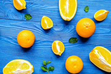 Cut oranges for juicy breakfast on blue background top view patt