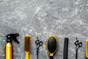 Tools for hairdress in barbershop on gray background top view mo