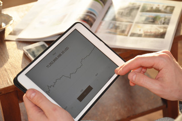 tablet in hands. crypto currency