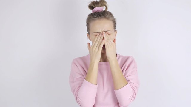 Young woman rubs her eyes. Eyes rubbing concept