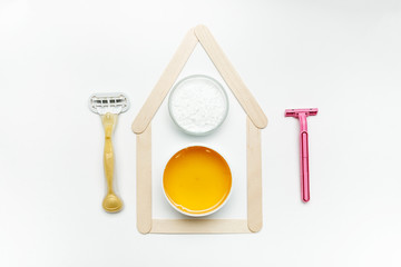 Tools for depilation on a white background, top view