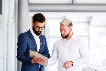 Young Business Colleagues Analyzing Financial Report