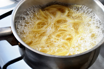 boiled spaghetti in water on fire