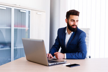 Sophisticated Young Businessman At Workplace