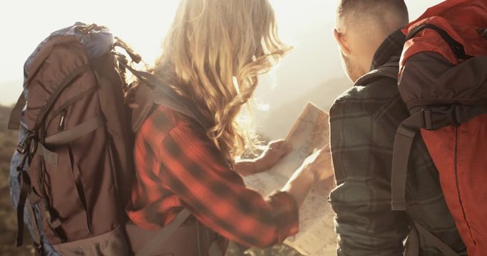 Senior woman and man reading a map on a mountain